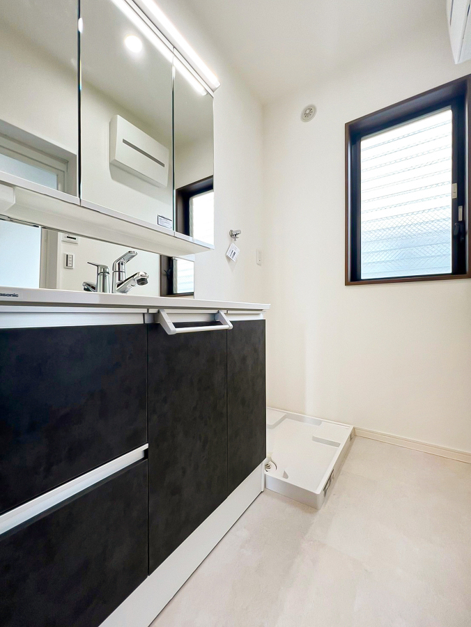 清潔感のあるシャワー付洗面台が完備され、広々とした洗面室